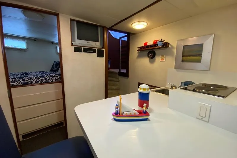  Yacht Photos Pics Interior of 1988 Burger 80 Motor Yacht with kitchenette and cozy sleeping area.