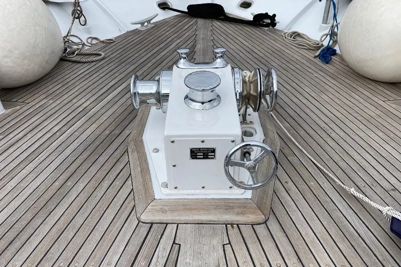  Yacht Photos Pics Anchor winch on 1988 Burger 80 Motor Yacht deck with wooden flooring.