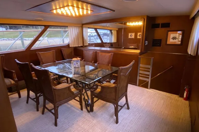  Yacht Photos Pics Luxurious dining area on 1988 Burger 80 Motor Yacht with glass table and elegant chairs.