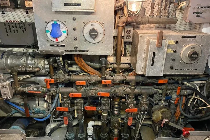  Yacht Photos Pics Engine room of a 1988 Burger 80 Motor Yacht with complex piping and control panels.