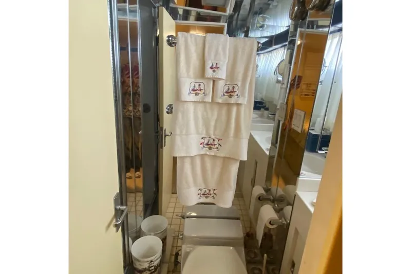  Yacht Photos Pics Bathroom interior of 1988 Burger 80 Motor Yacht with embroidered towels and modern fixtures.