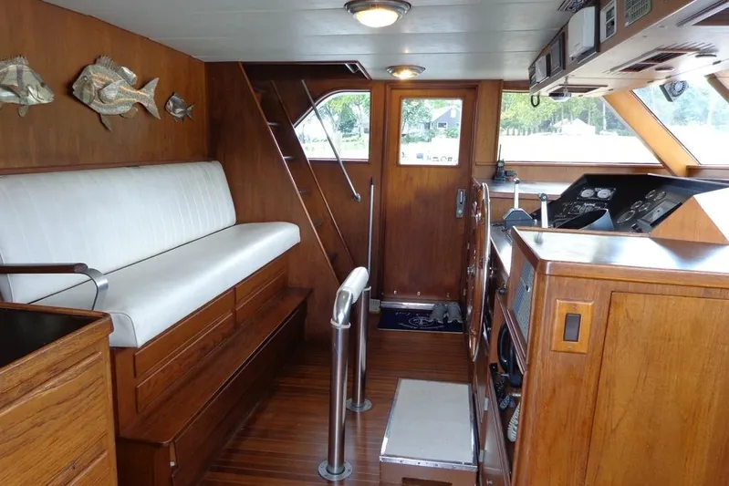  Yacht Photos Pics Interior of 1988 Burger 80 Motor Yacht with wooden finish and white seating.