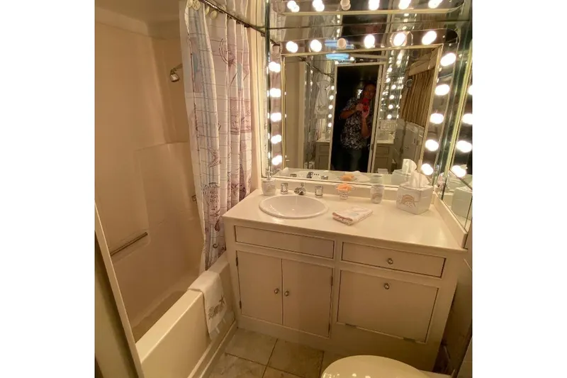  Yacht Photos Pics Luxurious bathroom on 1988 Burger 80 Motor Yacht with vanity and illuminated mirror.