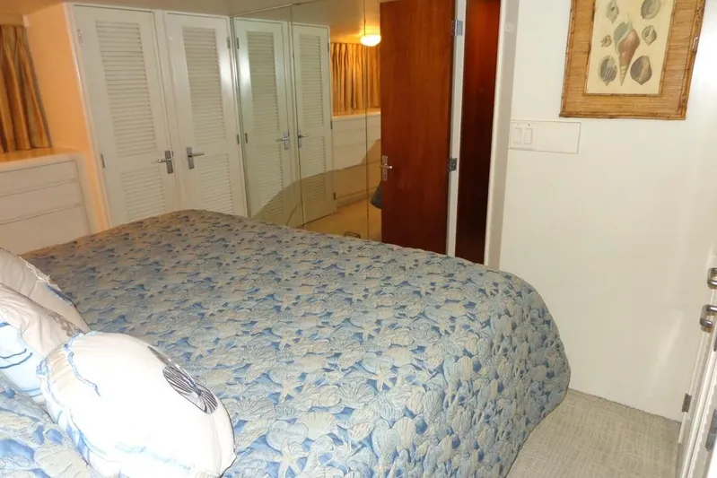  Yacht Photos Pics Cozy bedroom in 1988 Burger 80 Motor Yacht with floral bedding and closet.