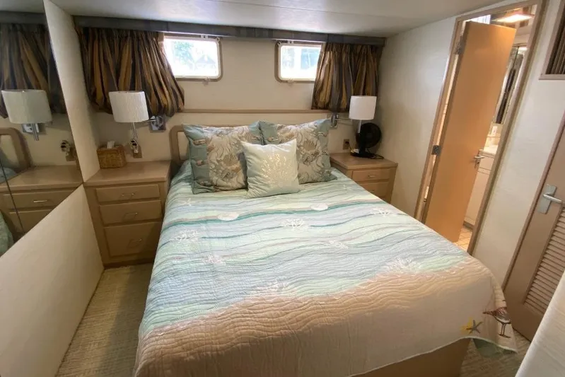  Yacht Photos Pics Cozy bedroom in 1988 Burger 80 Motor Yacht with nautical decor and natural light.
