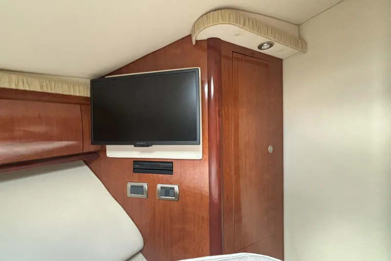  Yacht Photos Pics Interior of 2005 Sea Ray 420 Sundancer with mounted TV and wooden cabinetry.
