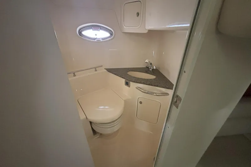  Yacht Photos Pics 2005 Sea Ray 420 Sundancer bathroom with sink, toilet, and porthole window.