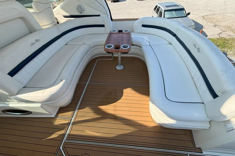  Yacht Photos Pics Luxurious seating area on 2005 Sea Ray 420 Sundancer yacht with wooden deck and table.