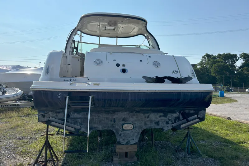  Yacht Photos Pics 2005 Sea Ray 420 Sundancer yacht on land, rear view with ladder and open cockpit.