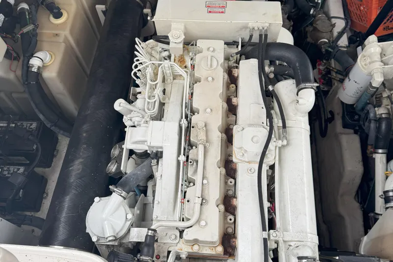  Yacht Photos Pics Engine compartment of a 2005 Sea Ray 420 Sundancer, showcasing mechanical components and hoses.