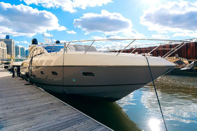  Yacht Photos Pics Luxurious 2014 Sunseeker Predator 60 yacht docked in a sunny marina setting.
