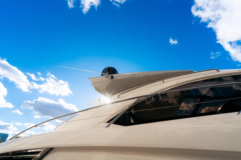  Yacht Photos Pics Sunseeker Predator 60 yacht, 2014 model, under a bright blue sky with clouds.