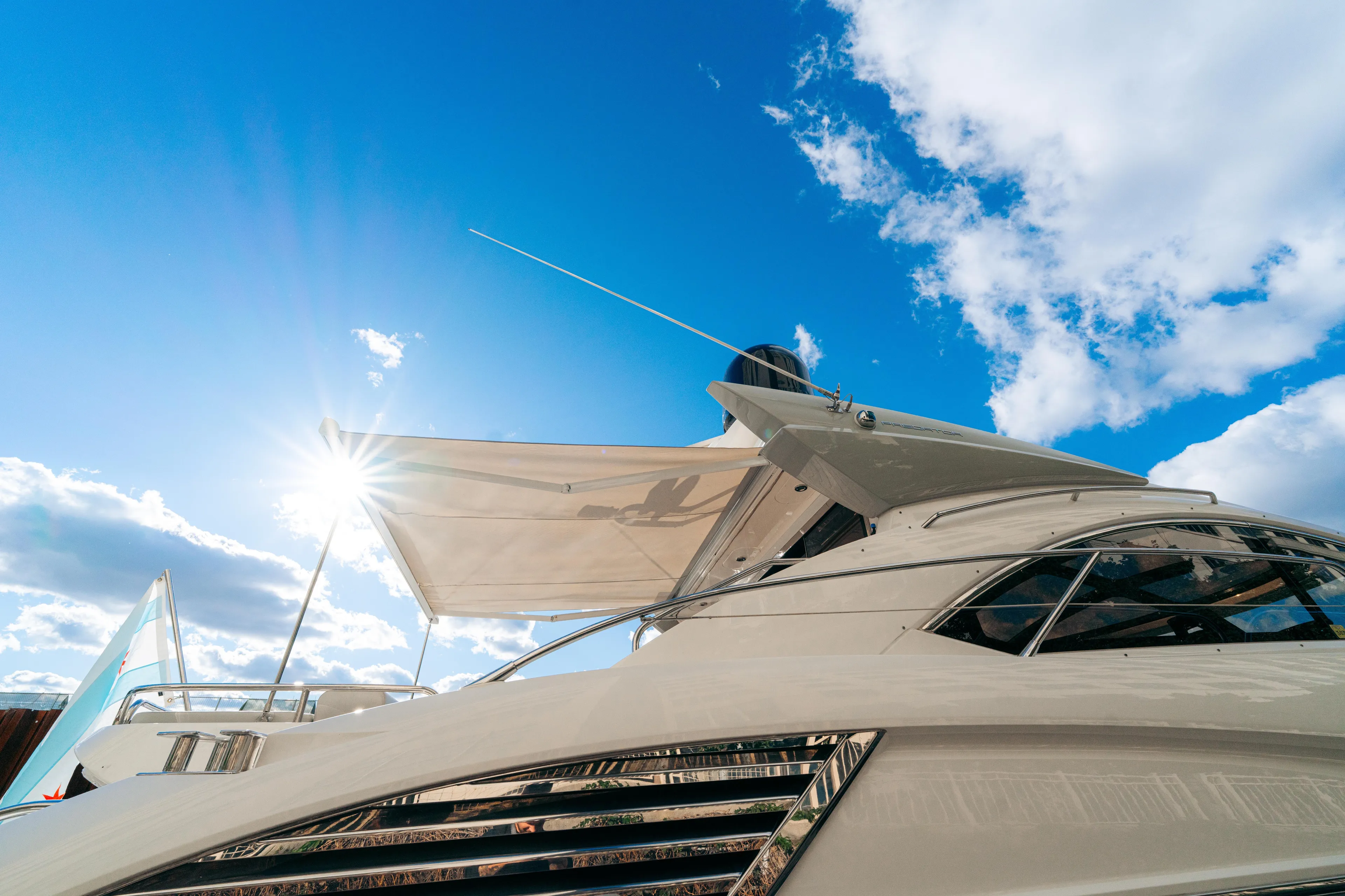  Yacht Photos Pics Sunseeker Predator 60 yacht, 2014 model, under clear blue sky with sun shining.