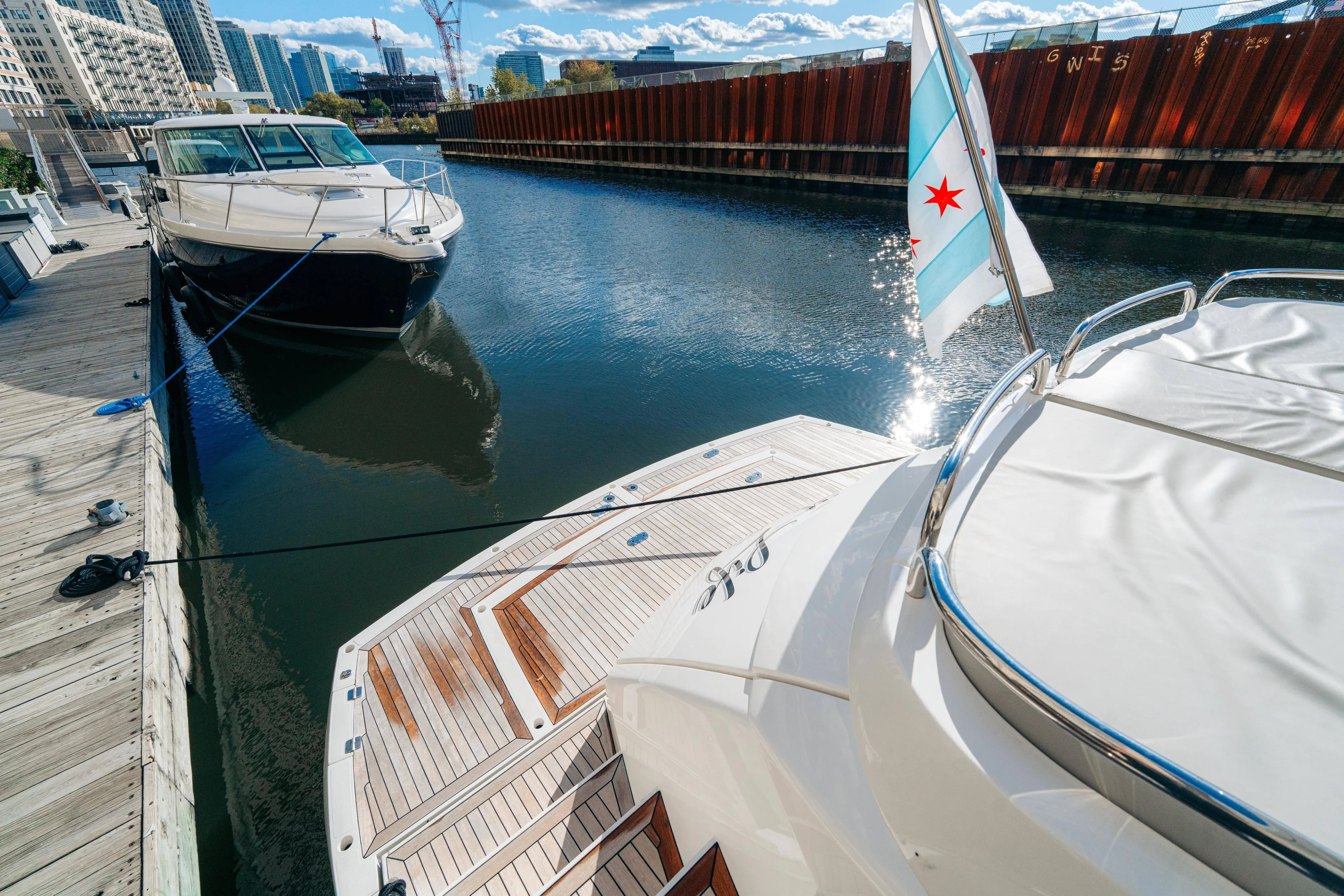  Yacht Photos Pics 2014 Sunseeker Predator 60 yacht docked in urban marina, Chicago flag visible.