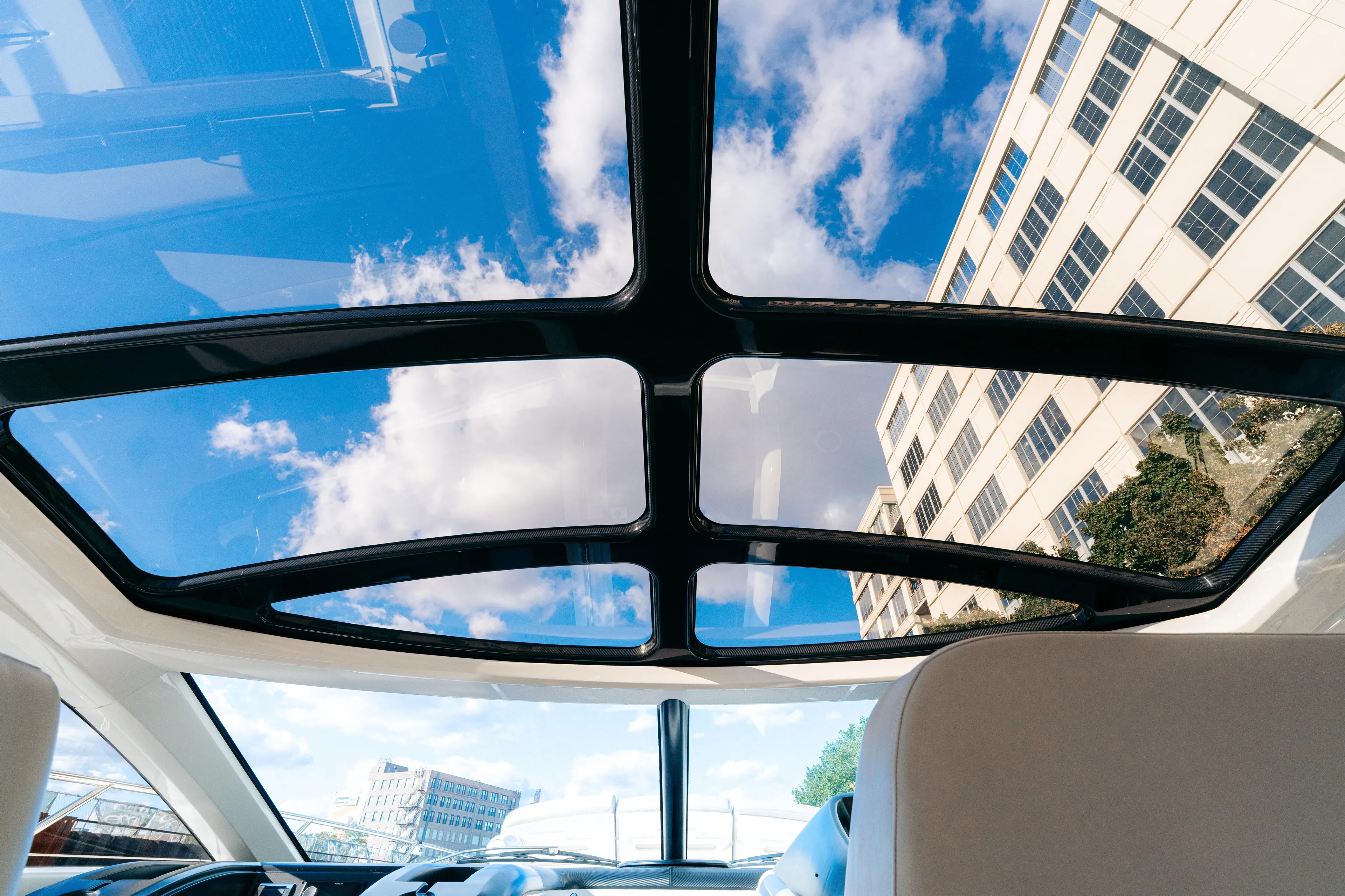  Yacht Photos Pics Glass roof view from 2014 Sunseeker Predator 60 yacht, showcasing blue sky and clouds.