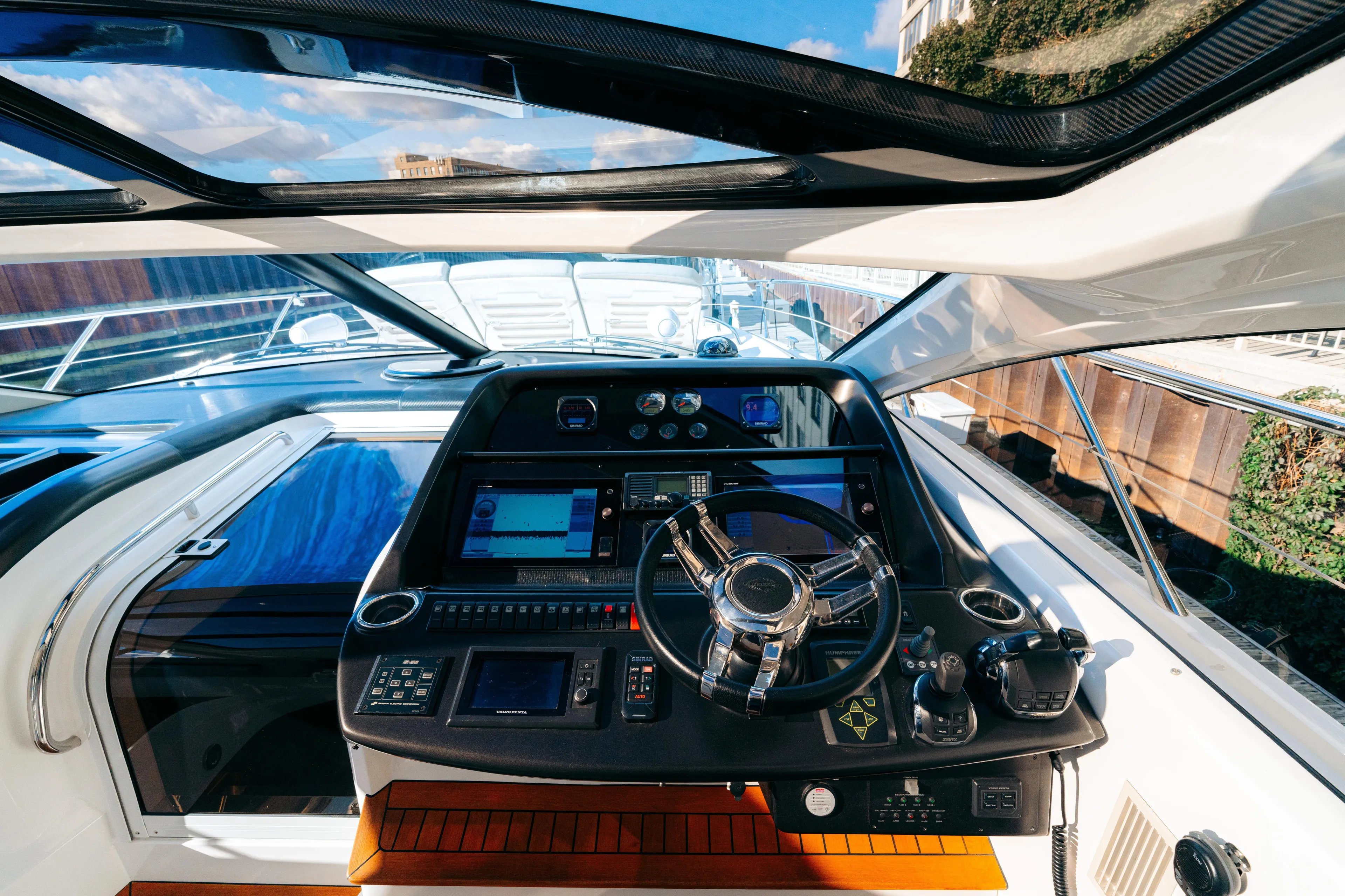  Yacht Photos Pics Cockpit of 2014 Sunseeker Predator 60 yacht with modern navigation controls and steering wheel.