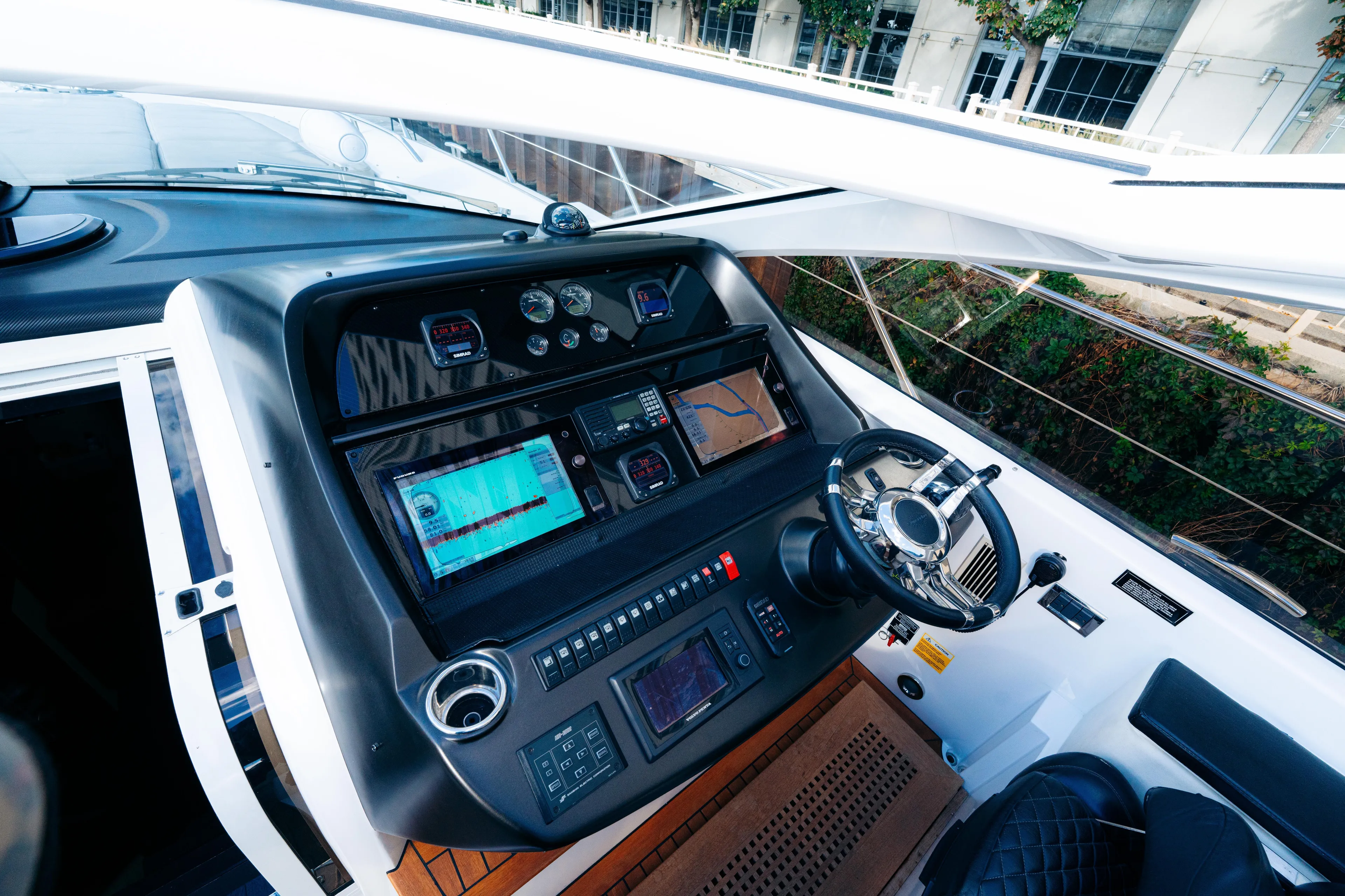  Yacht Photos Pics Cockpit of 2014 Sunseeker Predator 60 yacht with advanced navigation controls and steering wheel.