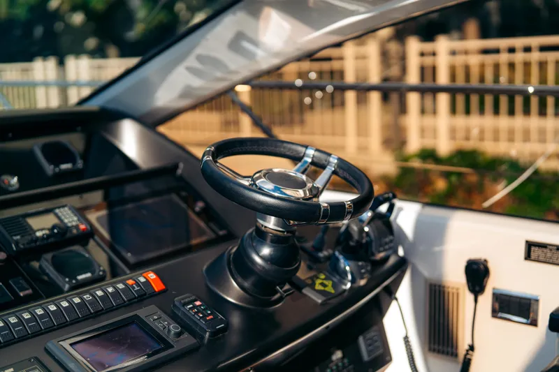  Yacht Photos Pics Control panel of a 2014 Sunseeker Predator 60 yacht, featuring steering wheel and navigation equipment.