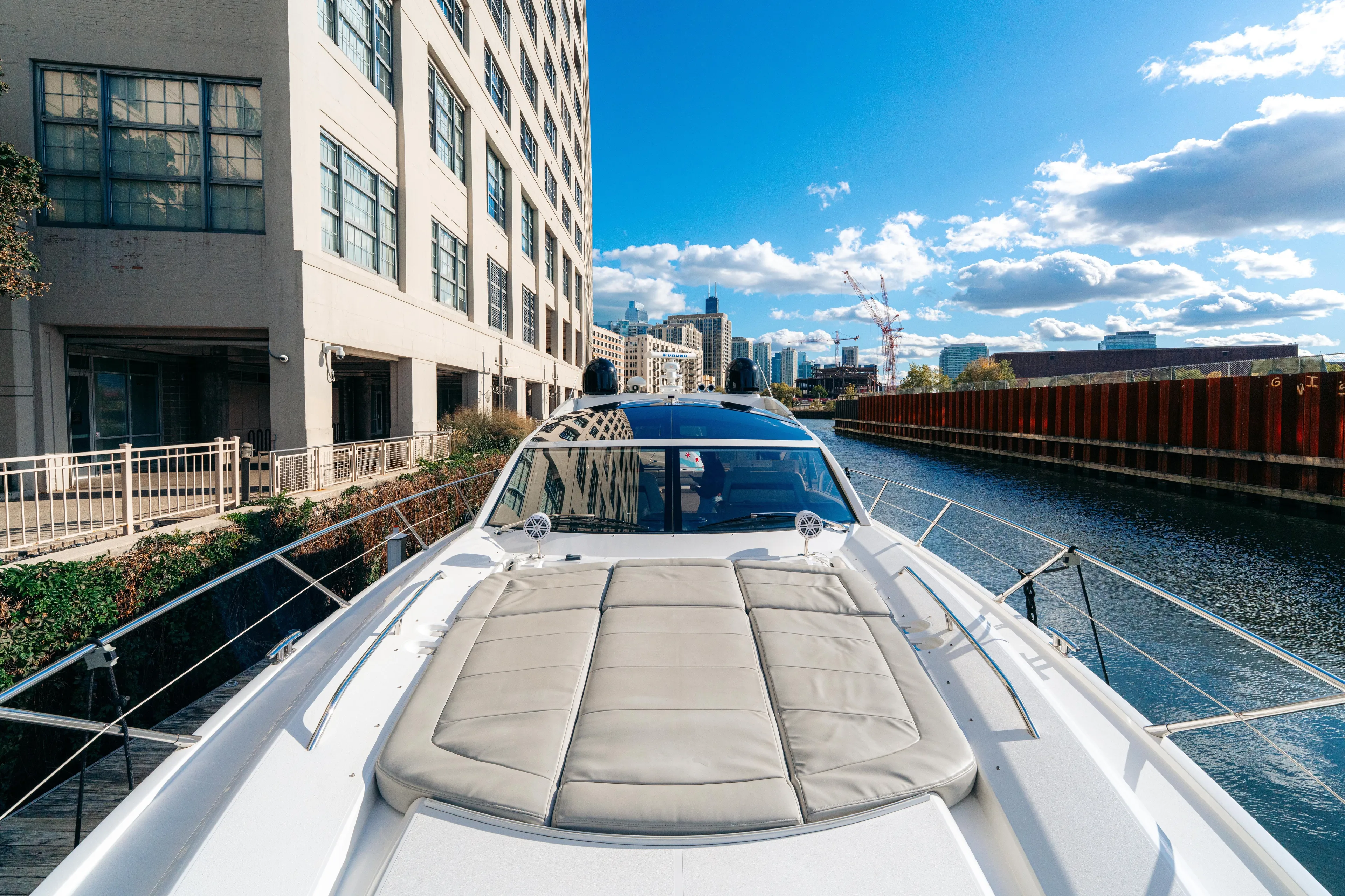  Yacht Photos Pics 2014 Sunseeker Predator 60 yacht docked by urban waterfront, sunny day.