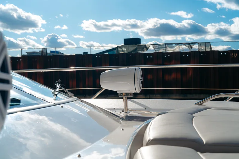 Yacht Photos Pics 2014 Sunseeker Predator 60 yacht deck with speaker, under a bright blue sky.