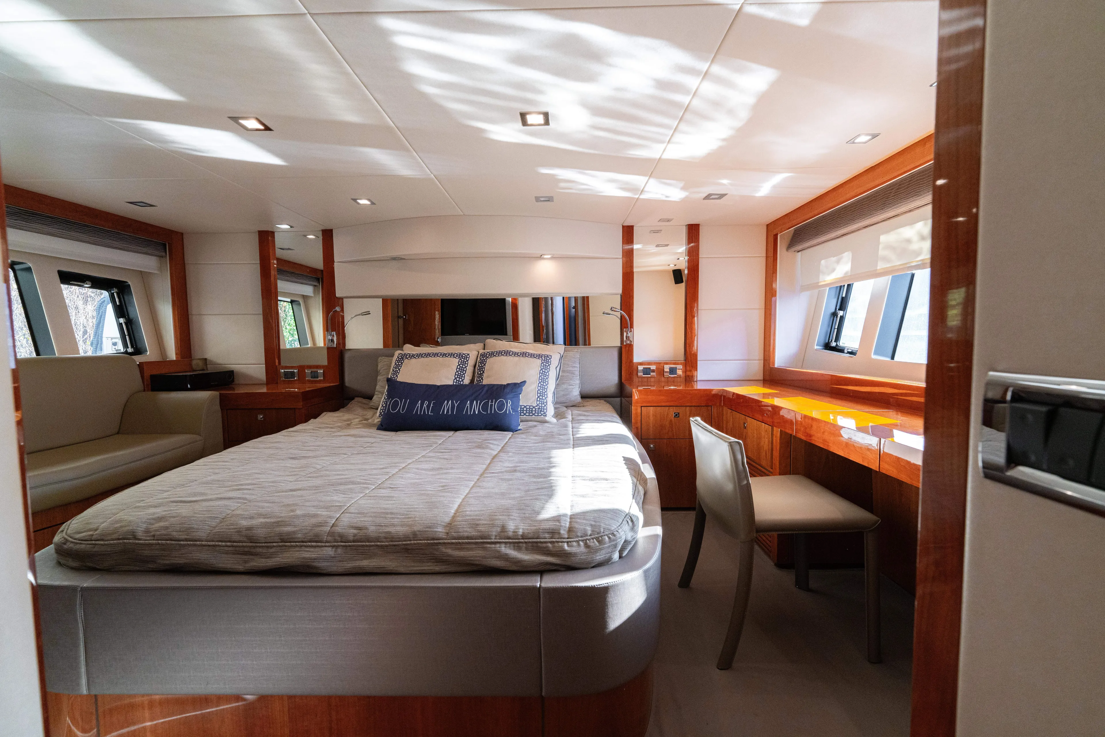  Yacht Photos Pics Luxurious bedroom interior of 2014 Sunseeker Predator 60 yacht with elegant wood finishes.