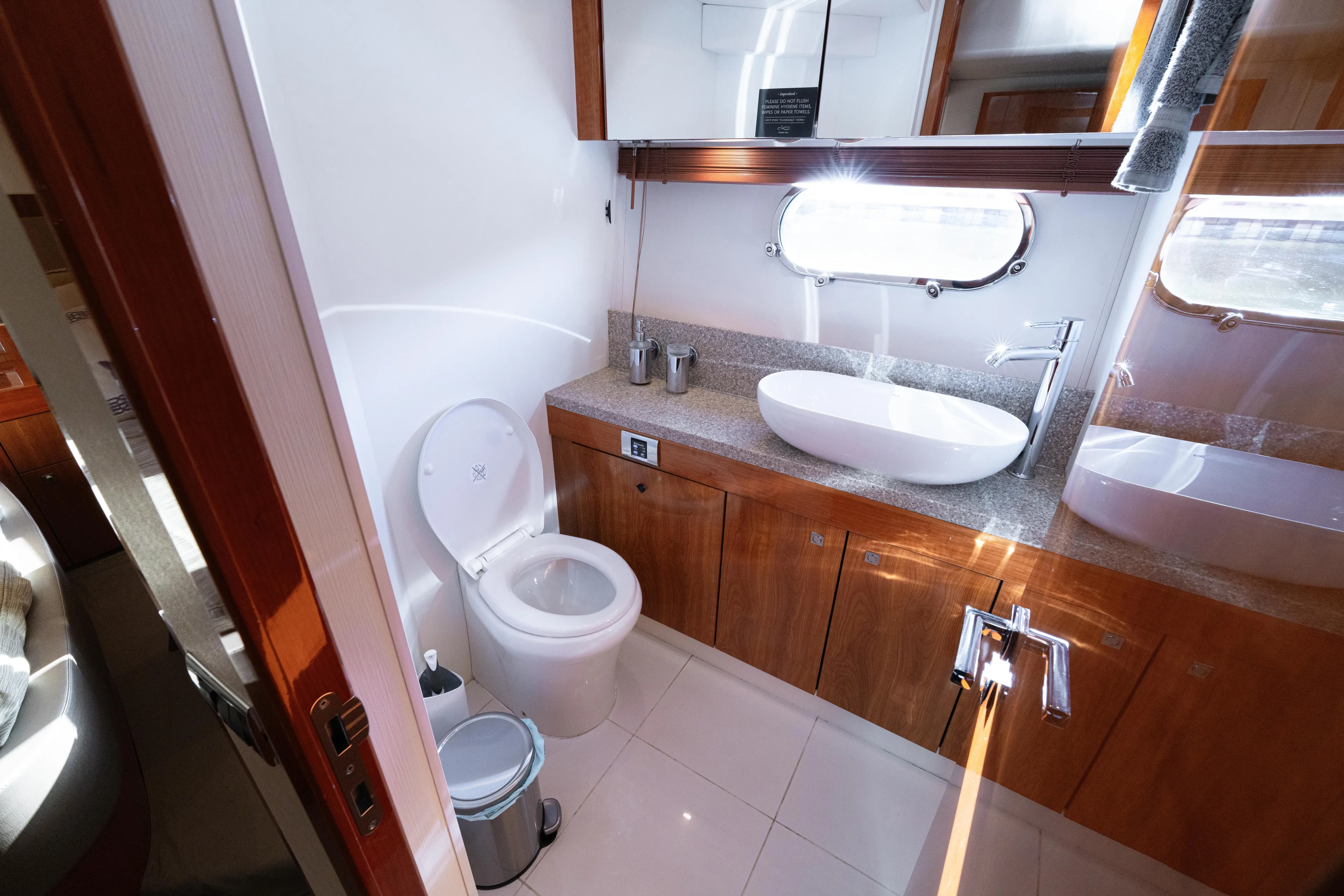  Yacht Photos Pics Luxurious bathroom in 2014 Sunseeker Predator 60 yacht with modern fixtures and wood cabinetry.