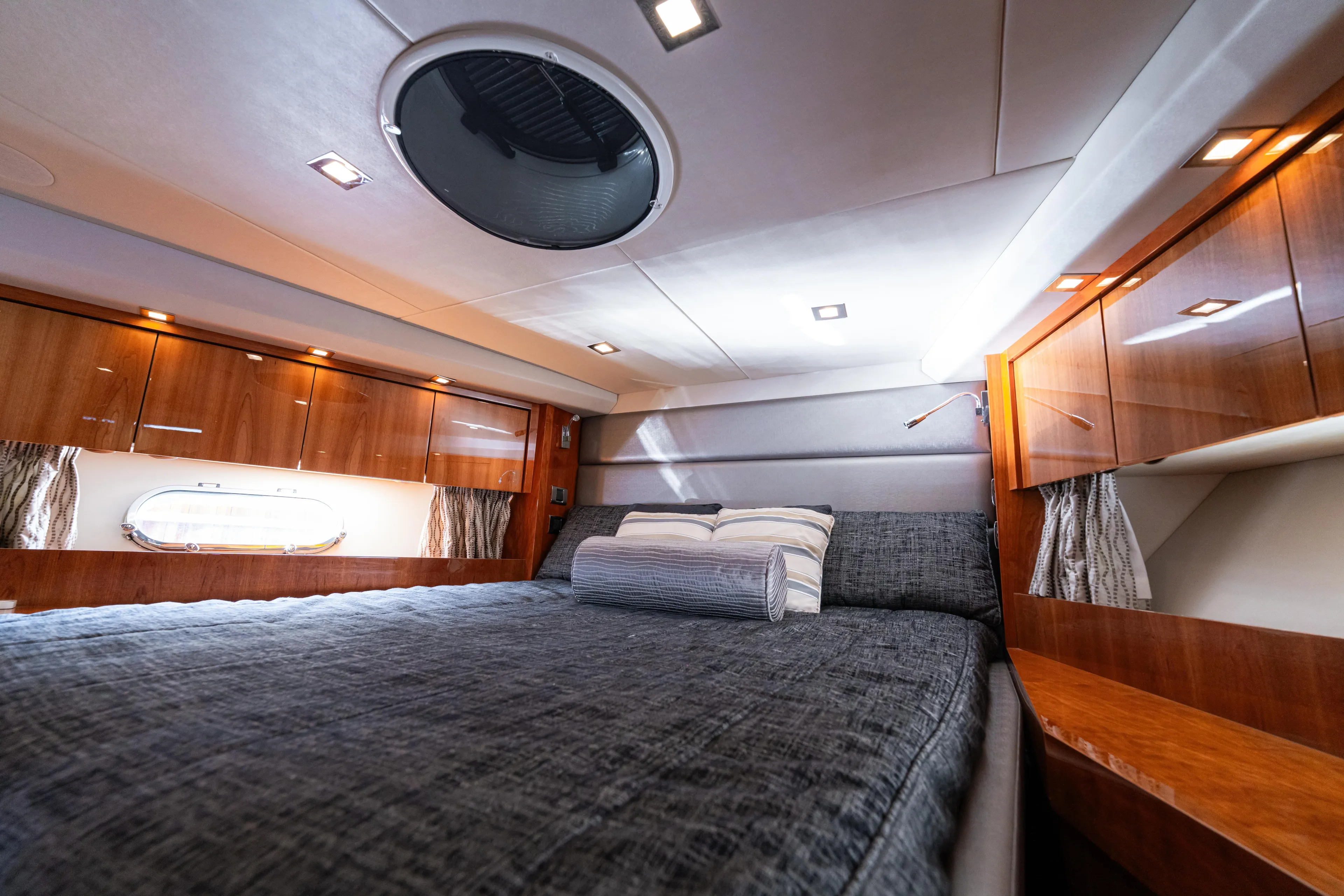  Yacht Photos Pics Luxurious bedroom interior of 2014 Sunseeker Predator 60 yacht with elegant wood finishes.