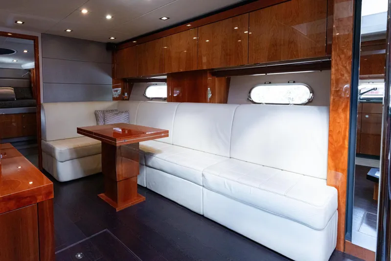  Yacht Photos Pics Luxurious interior of 2014 Sunseeker Predator 60 yacht with white leather seating and wooden accents.