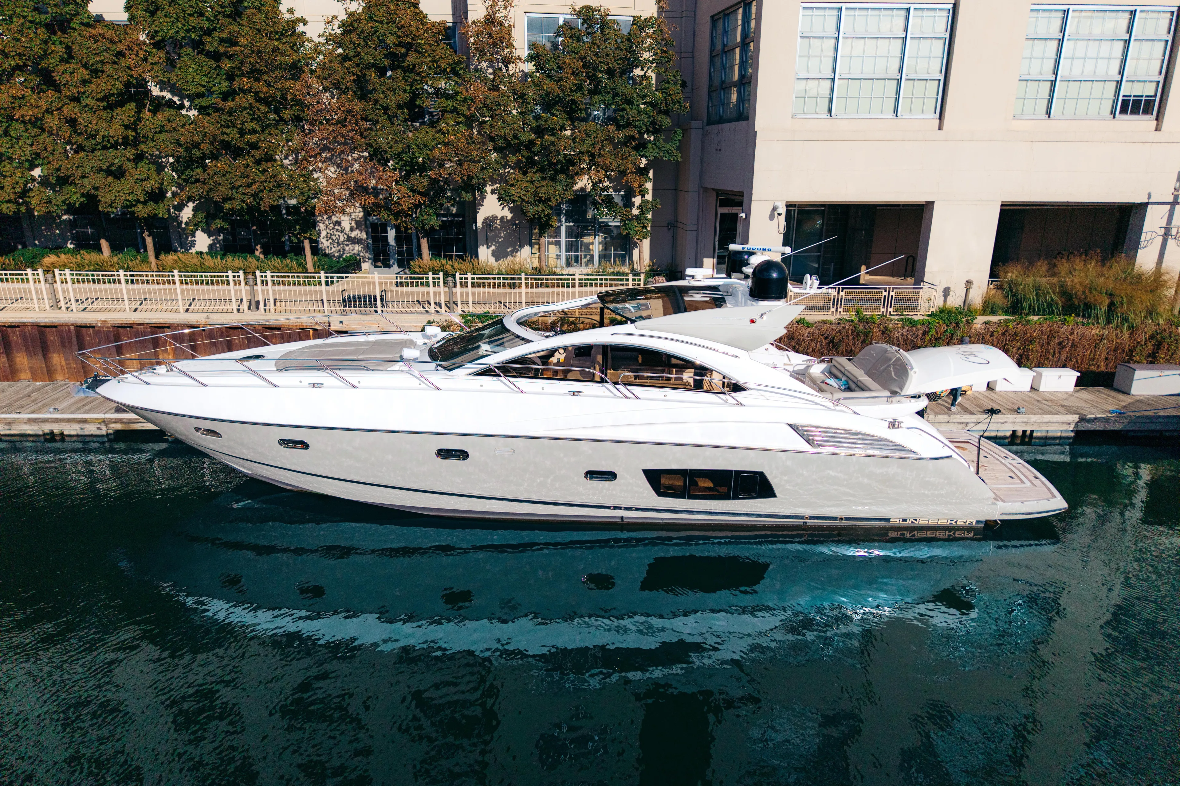  Yacht Photos Pics 2014 Sunseeker Predator 60 yacht docked by waterfront buildings.