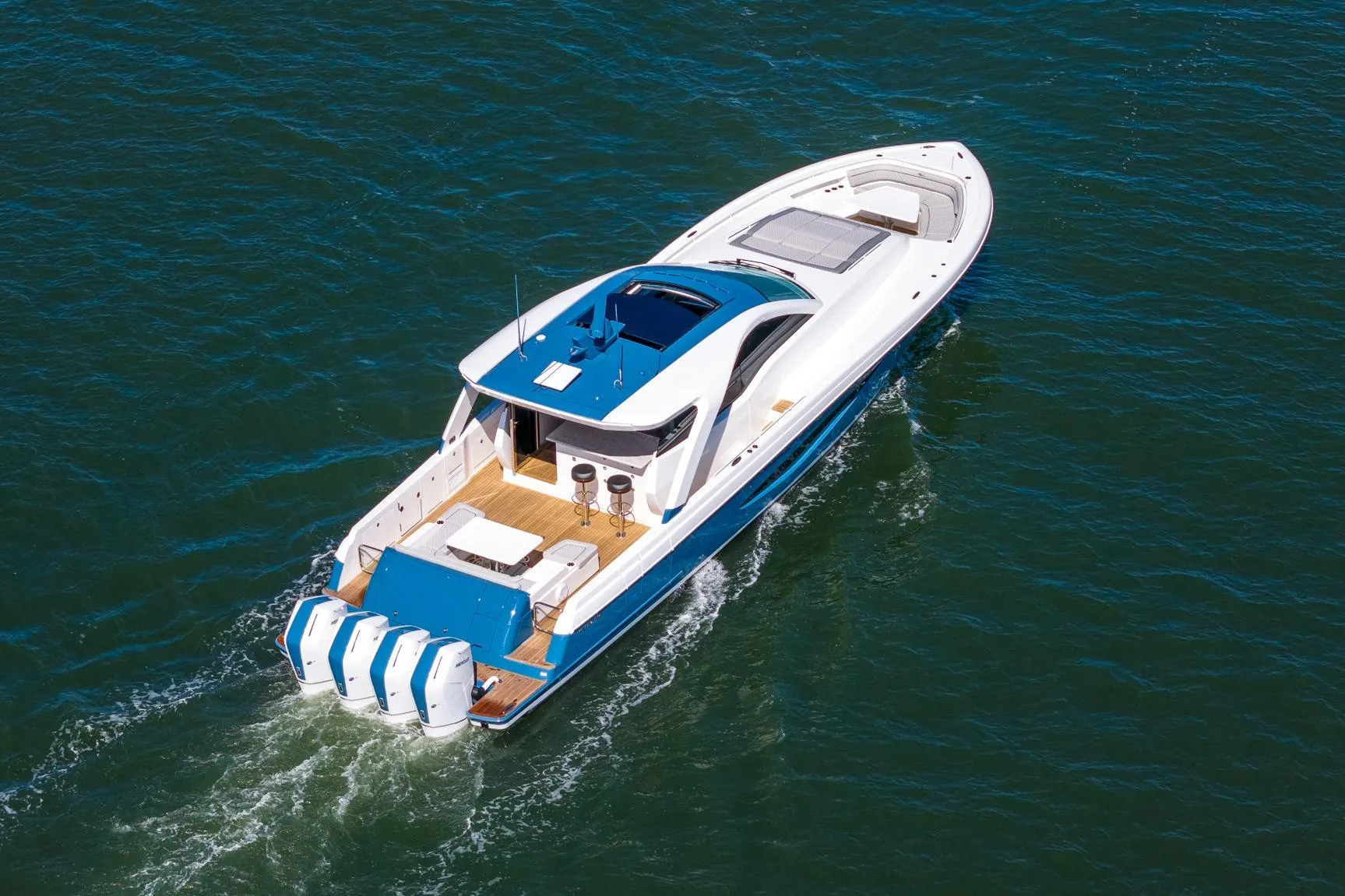 2026 Valhalla Boatworks V-55 Sport Yacht cruising on open water, rear view.