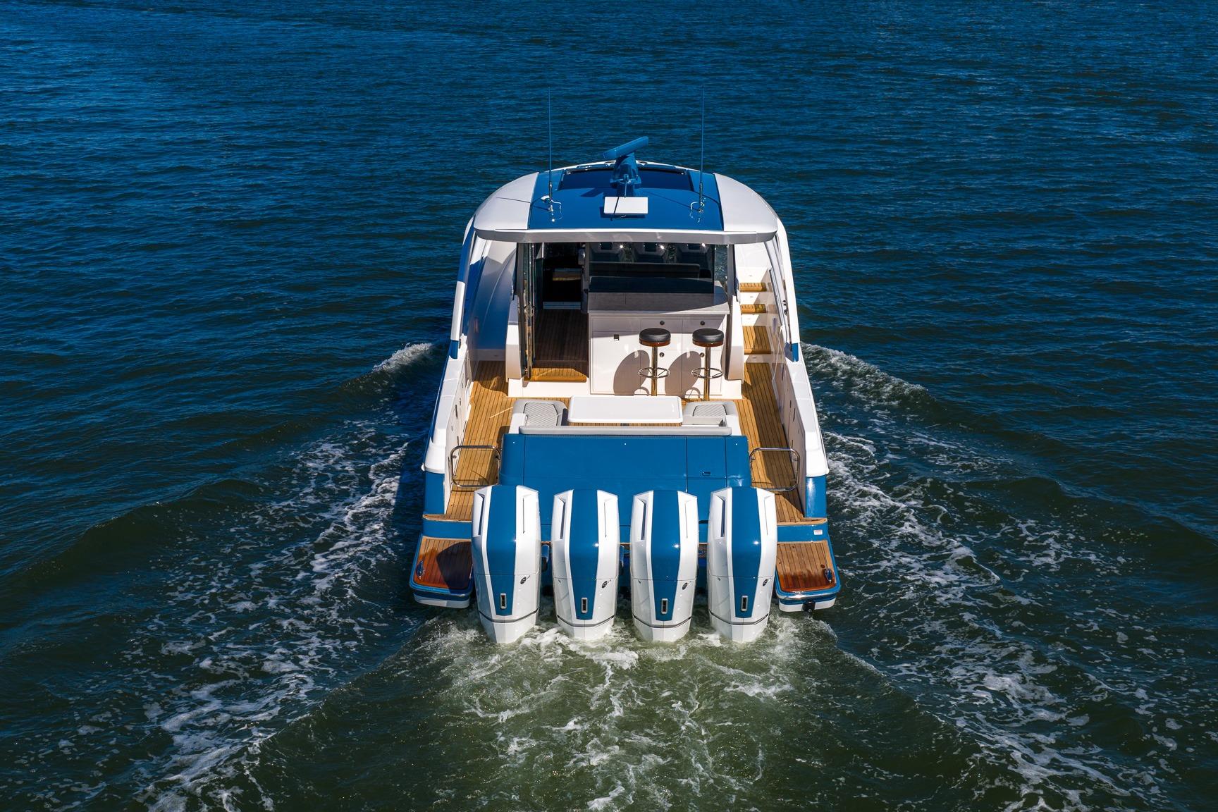 2026 Valhalla Boatworks V-55 Sport Yacht cruising on open water, rear view.