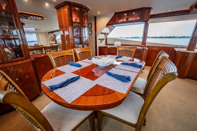 Water Ranch Yacht Photos Pics Luxurious dining area on 2003 Lazzara 80 EB yacht with elegant wood finish and ocean view.