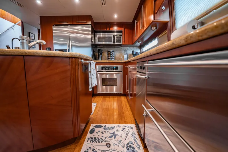 Water Ranch Yacht Photos Pics Luxurious kitchen interior of 2003 Lazzara 80 EB yacht with modern appliances and wood finishes.