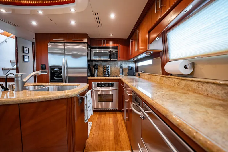 Water Ranch Yacht Photos Pics Luxurious kitchen interior of 2003 Lazzara 80 EB yacht with modern appliances and wood cabinetry.