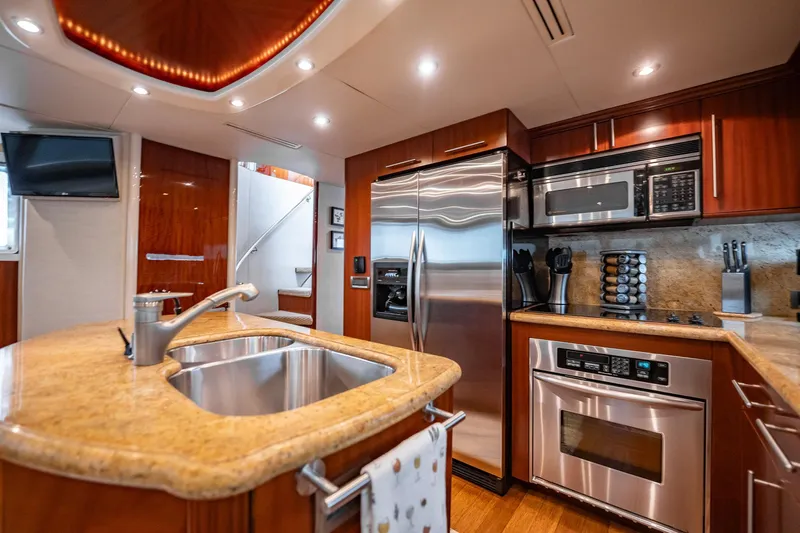 Water Ranch Yacht Photos Pics Luxurious kitchen interior of 2003 Lazzara 80 EB yacht with modern appliances and wood finishes.