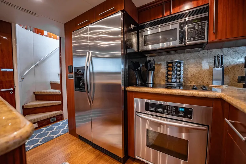 Water Ranch Yacht Photos Pics Luxurious 2003 Lazzara 80 EB yacht kitchen with stainless steel appliances and wooden cabinetry.