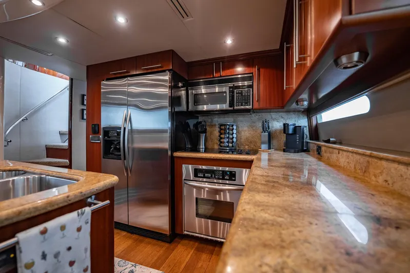 Water Ranch Yacht Photos Pics Luxurious kitchen interior of 2003 Lazzara 80 EB yacht with modern appliances and wood finishes.