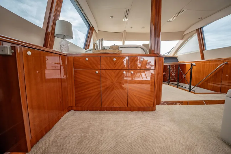 Water Ranch Yacht Photos Pics Luxurious interior of 2003 Lazzara 80 EB yacht with polished wood cabinetry and modern decor.