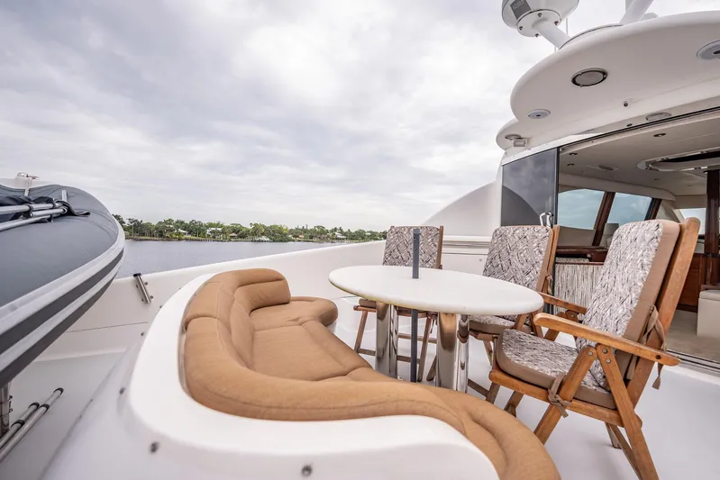 Water Ranch Yacht Photos Pics Luxurious 2003 Lazzara 80 EB yacht deck with seating and table, overlooking serene waters.