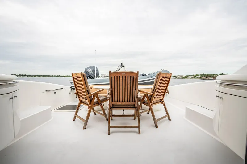 Water Ranch Yacht Photos Pics Deck of 2003 Lazzara 80 EB yacht with wooden chairs and table.