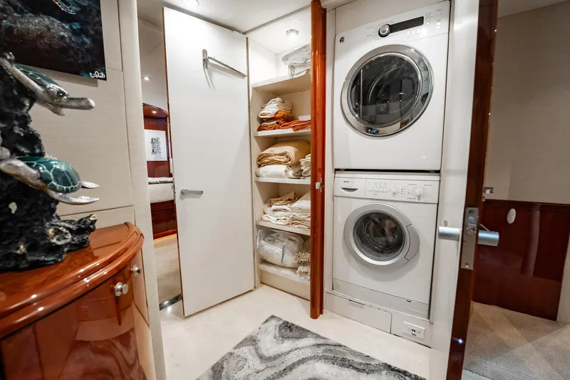 Water Ranch Yacht Photos Pics Laundry area on 2003 Lazzara 80 EB yacht with stacked washer and dryer.