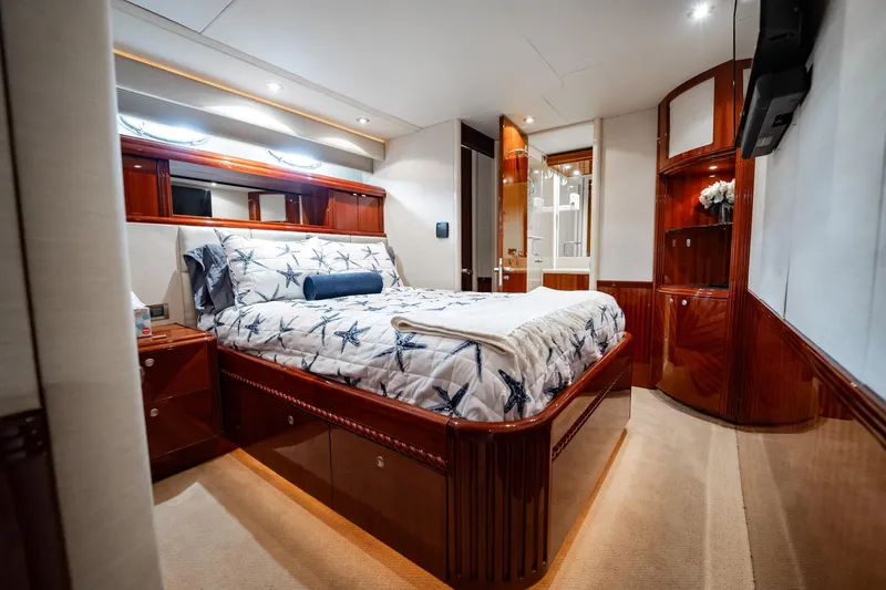 Water Ranch Yacht Photos Pics Luxurious bedroom interior of 2003 Lazzara 80 EB yacht with elegant wood finishes.