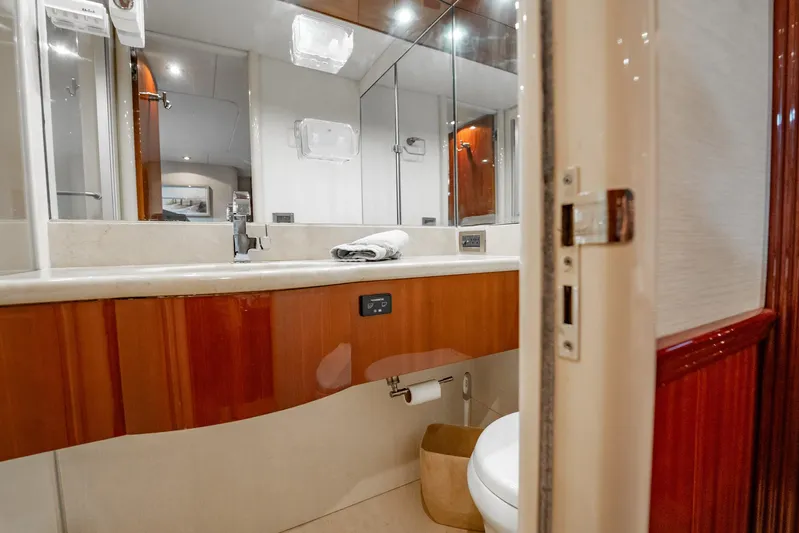 Water Ranch Yacht Photos Pics Luxurious bathroom interior of 2003 Lazzara 80 EB yacht with wood accents and modern fixtures.