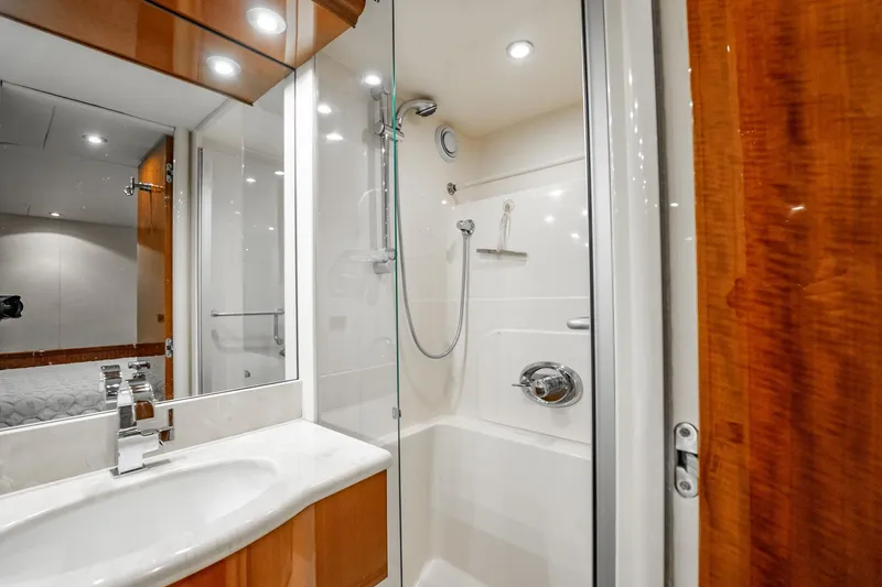 Water Ranch Yacht Photos Pics Luxurious bathroom in 2003 Lazzara 80 EB yacht with modern fixtures and elegant wood accents.