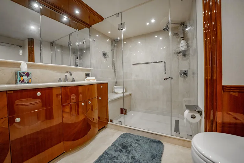 Water Ranch Yacht Photos Pics Luxurious bathroom on 2003 Lazzara 80 EB yacht with glass shower and wooden cabinetry.