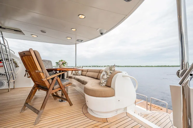 Water Ranch Yacht Photos Pics Luxurious 2003 Lazzara 80 EB yacht deck with seating, table, and ocean view.