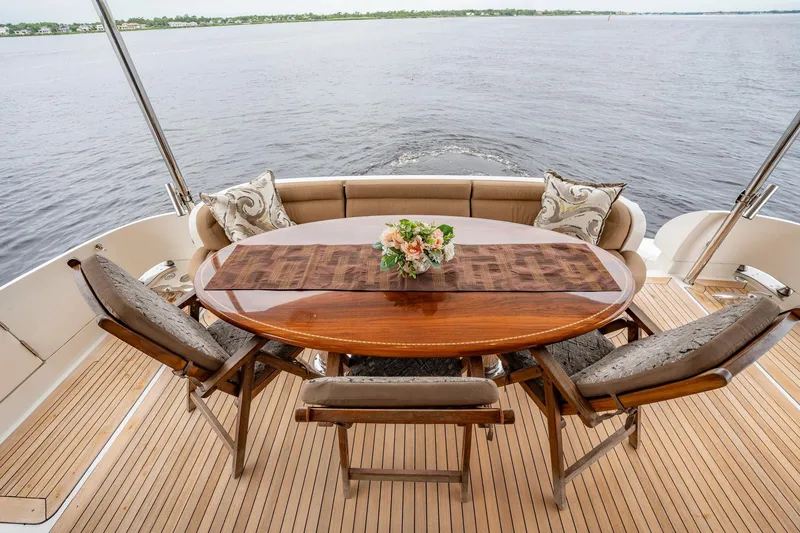 Water Ranch Yacht Photos Pics Luxurious 2003 Lazzara 80 EB yacht deck with elegant dining setup and scenic water view.