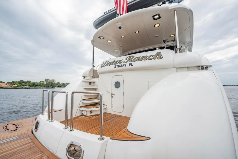 Water Ranch Yacht Photos Pics Luxury yacht Lazzara 80 EB 2003, docked with elegant wooden deck and American flag.