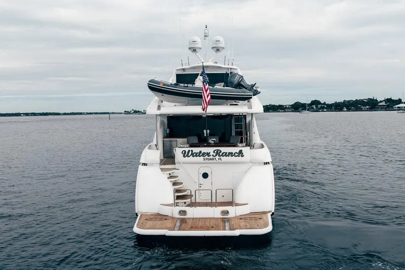 Water Ranch Yacht Photos Pics 2003 Lazzara 80 EB yacht on water, rear view with American flag.