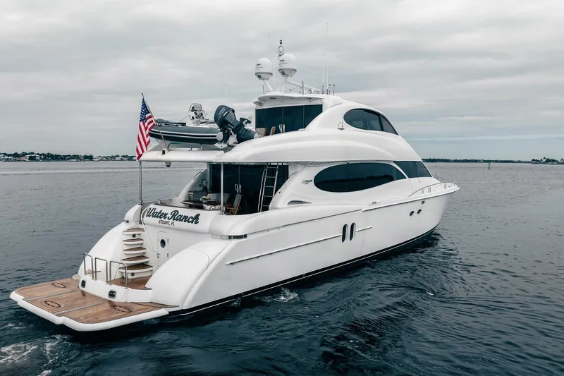 Water Ranch Yacht Photos Pics Luxury 2003 Lazzara 80 EB yacht cruising on open water, featuring sleek design and American flag.